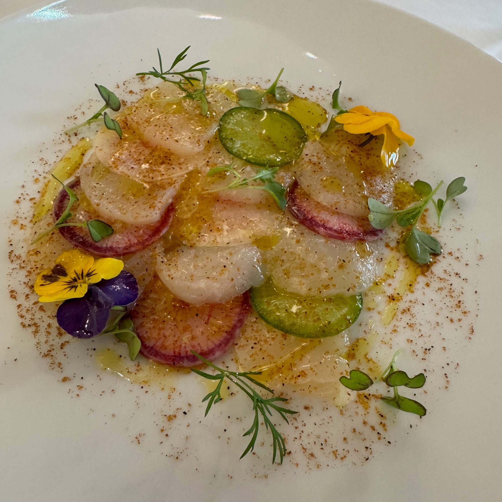 Root vegetables with citrus and young herbs — a delicate, season-led plate from Arpège, Paris