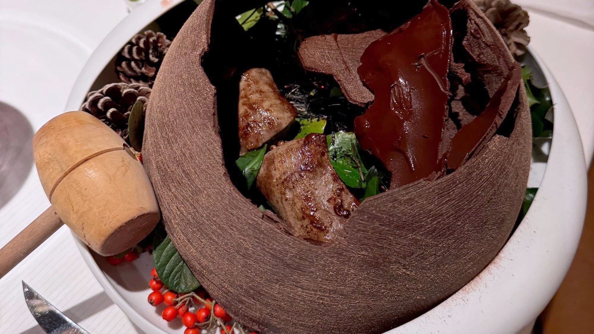 Venison saddle presented under a cracked Chanchamayo chocolate dome at Pierre Gagnaire in Paris.