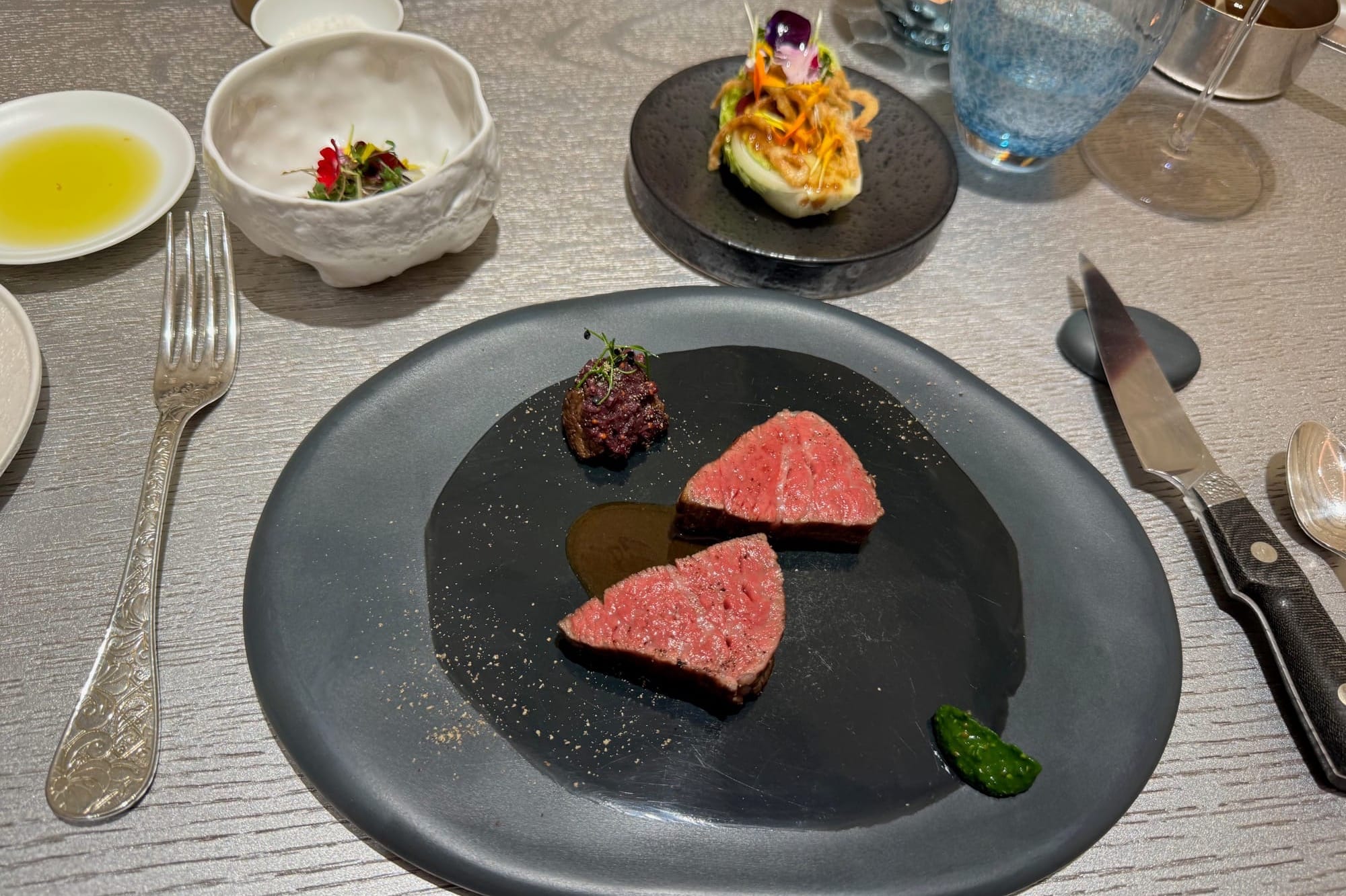 Kei Restaurant Paris - Wagyu grilled from Gunma at the barbecue, served with a piece of its fat, lacquered with soy sauce, horseradish, watercress, and old-fashioned mustard condiment. Wagyu tartare, yukke seasoning, puffed rice. Salad, fried onions and sour dressing.