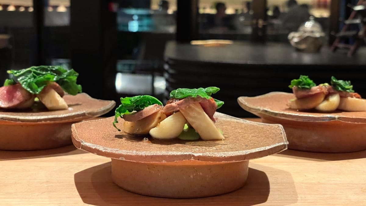 ine dining dish presented on ceramic plates in a modern restaurant setting.