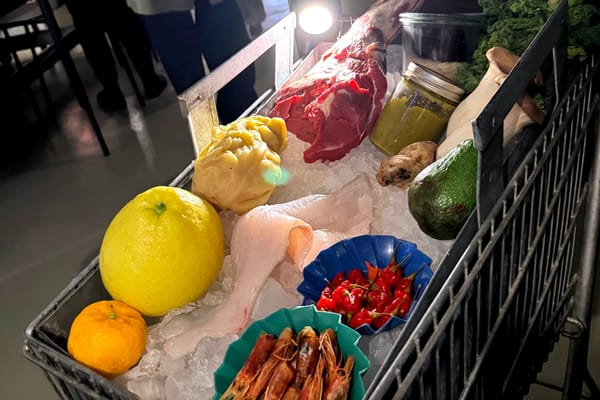 A metal market trolley, neatly arranged with the evening’s key ingredients—seasonal vegetables, herbs, fish, and game—presented tableside as an introduction to the tasting menu.